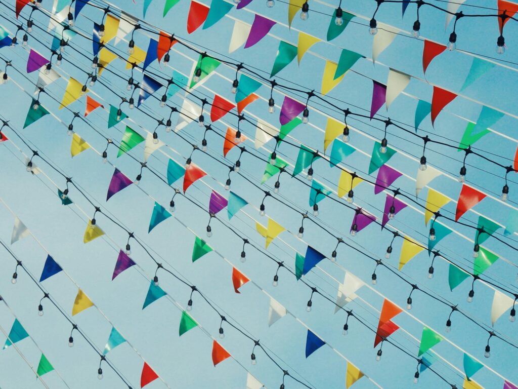 Vibrant triangular flags and lights strung in the sky, perfect for festive scenes.